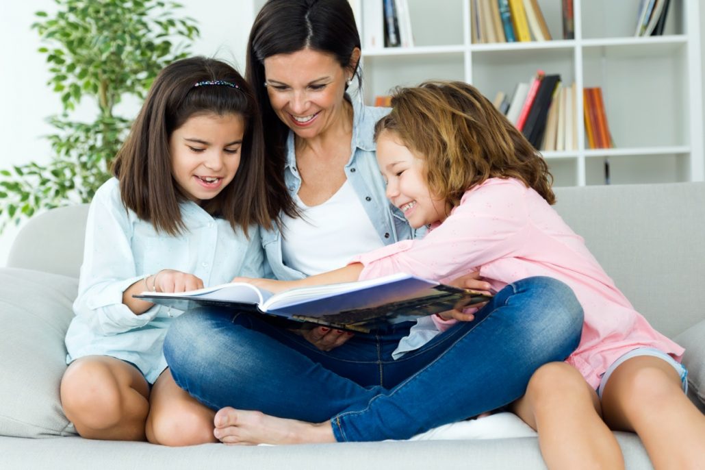 Mother and daughters reading together